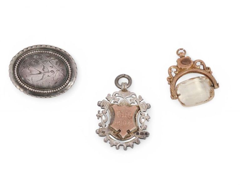 Collection of three pendants and brooch