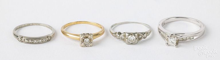 Four 14k gold diamond rings