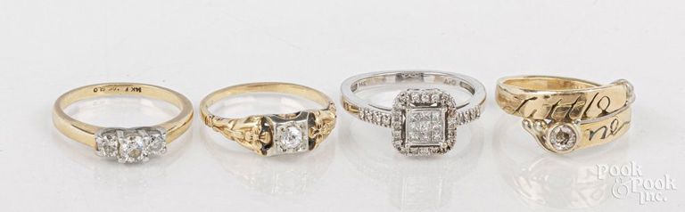 Four 14k gold diamond rings